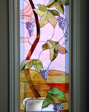 A potted grape vine stained glass panel by Casa Loma Art Glass.