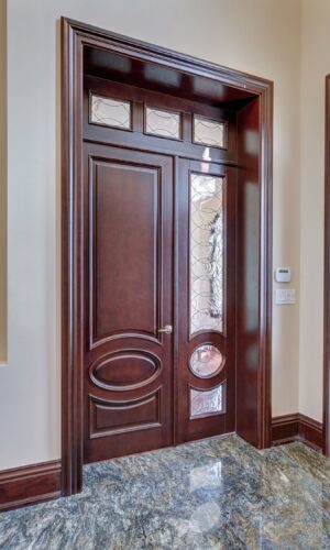 Entryway with dark wood door featuring the Door Glass Insert - Rio and marble flooring in bright natural light.