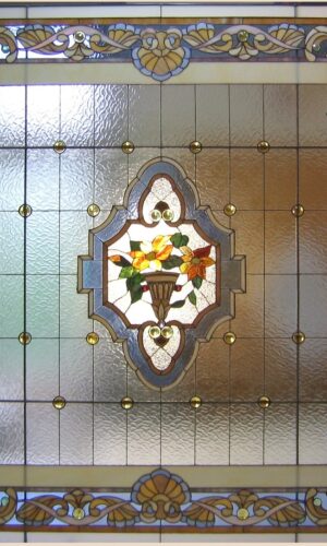 Artisan Stained Glass Window 3 features a central floral vase with intricate geometric and floral border patterns.