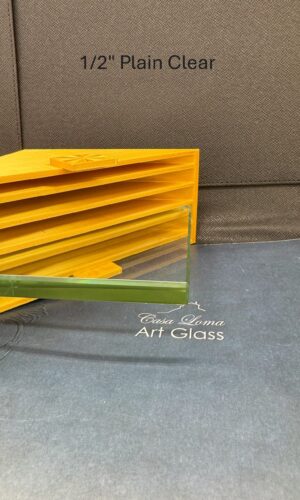 A 1/2″ Thick Plain Clear Glass Shelf rests on blue, with a yellow holder and background text.
