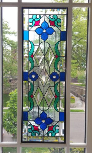 Art Stained Glass Window with Bevels featuring blue, green, and red floral patterns in a tall white frame.