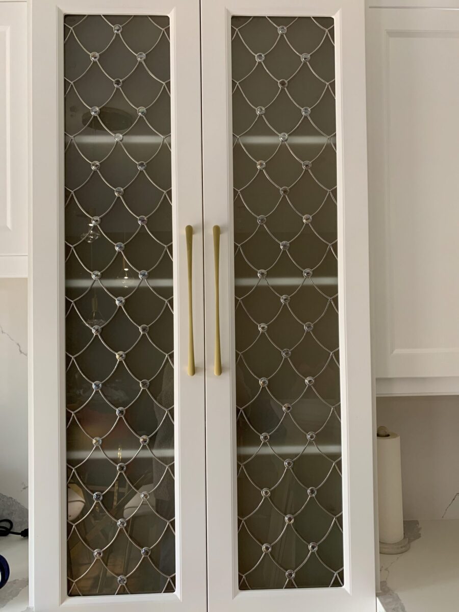 Venezzia white cabinet with 2 glass doors, diamond lattice art glass, and gold handles.