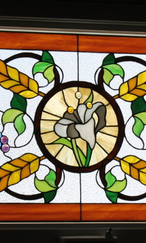 Traditional Stained Glass Design with wheat, grapes, green leaves, center white lily, and amber border.