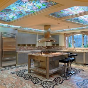 Luxury kitchen with stainless steel appliances, marble floors, and stained glass ceiling panels.
